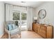 Bedroom seating area with a comfy chair, a balcony, and a stylish bamboo dresser at 9 Fairway Dunes Ln, Isle of Palms, SC 29451