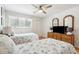 Bright bedroom with two twin beds, ceiling fan, and large window at 9 Fairway Dunes Ln, Isle of Palms, SC 29451