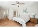 Cozy bedroom with a queen-sized bed, hardwood floors, and stylish turquoise bedside lamps at 9 Fairway Dunes Ln, Isle of Palms, SC 29451
