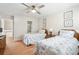 Cozy bedroom with two twin beds, ceiling fan, and ensuite bathroom at 9 Fairway Dunes Ln, Isle of Palms, SC 29451