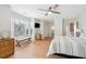 Spacious bedroom with large windows, a TV, a seating bench, and access to an ensuite bath at 9 Fairway Dunes Ln, Isle of Palms, SC 29451
