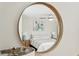 Bedroom reflected in a round mirror showing a queen-sized bed and stylish lamps at 9 Fairway Dunes Ln, Isle of Palms, SC 29451