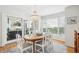 Light filled dining room with glass top table and seating for six, with access to screened in porch at 9 Fairway Dunes Ln, Isle of Palms, SC 29451