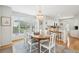 Elegant dining room featuring a chandelier, natural light, and an open layout to kitchen at 9 Fairway Dunes Ln, Isle of Palms, SC 29451