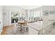 Bright dining room with wood table, decorative chandelier and large sliding doors to outdoor patio at 9 Fairway Dunes Ln, Isle of Palms, SC 29451