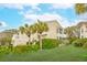 Exterior of a two-story villa with lush landscaping and blue skies at 9 Fairway Dunes Ln, Isle of Palms, SC 29451