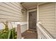 Inviting front porch with a screen door and stylish welcome mat at 9 Fairway Dunes Ln, Isle of Palms, SC 29451