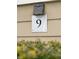 Close-up of the house number '9' on a neutral-toned exterior at 9 Fairway Dunes Ln, Isle of Palms, SC 29451