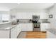 Bright kitchen featuring white cabinets, stainless steel appliances, and granite countertops at 9 Fairway Dunes Ln, Isle of Palms, SC 29451