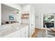 Bright kitchen bar with granite countertop open to dining room and view of living room at 9 Fairway Dunes Ln, Isle of Palms, SC 29451