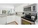 Modern kitchen featuring stainless steel appliances, white cabinets, and granite countertops at 9 Fairway Dunes Ln, Isle of Palms, SC 29451
