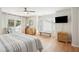Bright main bedroom with hardwood floors, balcony access, and a sitting area by a window at 9 Fairway Dunes Ln, Isle of Palms, SC 29451