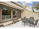 Outdoor patio featuring elegant metal furniture and sliding glass doors at 9 Fairway Dunes Ln, Isle of Palms, SC 29451