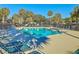 Refreshing community pool surrounded by lounge chairs and swaying palm trees at 9 Fairway Dunes Ln, Isle of Palms, SC 29451