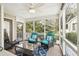 Relaxing screened porch featuring comfortable seating and scenic views at 9 Fairway Dunes Ln, Isle of Palms, SC 29451