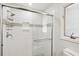 Modern tiled shower with glass door and a built-in shelf niche at 9 Fairway Dunes Ln, Isle of Palms, SC 29451