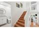 Well-lit staircase leads to a bathroom and open living area at 9 Fairway Dunes Ln, Isle of Palms, SC 29451