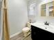 Well-lit bathroom featuring black vanity, neutral walls, and a modern design with updated fixtures at 104 Bryant St, Saint George, SC 29477