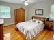 Cozy bedroom featuring hardwood floors, a ceiling fan, and an elegant wooden armoire at 104 Bryant St, Saint George, SC 29477