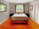 Cozy bedroom featuring wood floors, gray walls, and lots of natural light at 104 Bryant St, Saint George, SC 29477