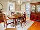 Cozy dining room with hardwood floors, chandelier, and seamless view into the kitchen at 104 Bryant St, Saint George, SC 29477