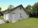 Spacious two-car garage with gray siding, side access door, and a well-maintained lawn at 104 Bryant St, Saint George, SC 29477