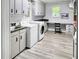Spacious laundry room featuring modern washer and dryer, ample counter space, and built-in cabinets at 104 Bryant St, Saint George, SC 29477