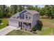 An aerial view showcases the home, highlighting the landscaped yard, two car garage, and inviting front porch at 107 Belgian Ct, Summerville, SC 29486