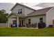 Spacious backyard patio with outdoor seating, dining area, and well-maintained lawn at 107 Belgian Ct, Summerville, SC 29486