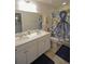 Bright bathroom featuring double sinks, white cabinets, and an octopus-themed shower curtain at 107 Belgian Ct, Summerville, SC 29486