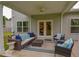 Relaxing covered patio with cozy seating, ceiling fan, and backyard views at 107 Belgian Ct, Summerville, SC 29486