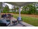 Inviting covered patio with comfortable seating and views of the expansive backyard at 107 Belgian Ct, Summerville, SC 29486