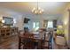 A dining room table with seating for six adjoins living room with fireplace, doors to outside, and nice wooden floors at 107 Belgian Ct, Summerville, SC 29486