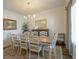 Bright dining room featuring an elegant chandelier, large window, and ample seating for eight at 107 Belgian Ct, Summerville, SC 29486