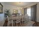 Bright dining room featuring an elegant chandelier, large window, and seating for eight at 107 Belgian Ct, Summerville, SC 29486