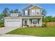 Charming two-story home with a well-manicured lawn and a welcoming front porch with rocking chairs at 107 Belgian Ct, Summerville, SC 29486