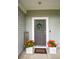 A welcoming front door with a decorative wreath, flanked by vibrant flower pots and a 'Cook Well' sign at 107 Belgian Ct, Summerville, SC 29486