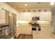 A full kitchen with stainless steel appliances, granite counters, white cabinets and wooden floors at 107 Belgian Ct, Summerville, SC 29486