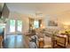 Bright living room with large sectional couch, side chairs, fireplace, TV, ceiling fan and doors to outside at 107 Belgian Ct, Summerville, SC 29486