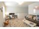 Living room with sofa, rug, rocking horse and desk with computer monitors at 107 Belgian Ct, Summerville, SC 29486