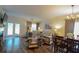 Bright living room with large sectional couch, side chairs, fireplace, TV, ceiling fan and doors to outside at 107 Belgian Ct, Summerville, SC 29486
