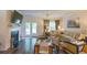 Bright living room with large sectional couch, side chairs, fireplace, TV, ceiling fan and doors to outside at 107 Belgian Ct, Summerville, SC 29486