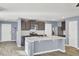 Open-concept kitchen with a center island, stainless steel appliances, and stylish dark cabinets at 116 Bright Meadow Rd, Summerville, SC 29483