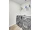 Modern laundry room with stainless steel washer, dryer, shelving, and vinyl floors at 116 Bright Meadow Rd, Summerville, SC 29483