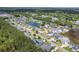 Aerial view of the community with winding roads, a pond, and plentiful trees at 1207 Rivers Reach Dr, Wando, SC 29492