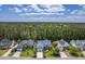 Aerial view of a well-maintained neighborhood showcasing attractive homes and mature trees on a sunny day at 1207 Rivers Reach Dr, Wando, SC 29492