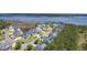 Scenic aerial shot of waterfront neighborhood featuring homes with private docks and lush greenery at 1207 Rivers Reach Dr, Wando, SC 29492