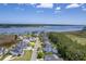 Beautiful aerial view of waterfront homes near the water with private docks on a sunny day at 1207 Rivers Reach Dr, Wando, SC 29492