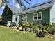 Backyard features a well-maintained lawn, a variety of plants, and a patio area at 1207 Rivers Reach Dr, Wando, SC 29492