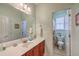 Bathroom featuring single vanity, white countertop, wood cabinets, and access to the toilet and shower at 1207 Rivers Reach Dr, Wando, SC 29492